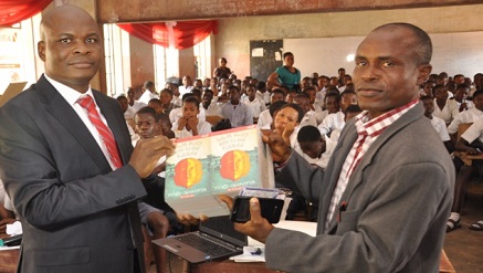 l-r: Executive Director, Lagos and West Bank, Marketing, United Bank for Africa, Liadi Ayoku donating books and other gift items  to the Vice Principal, Academic, Olivet Baptist High School, Oyo, Oyo State, Mr. E.A Adedeji,  during the financial literacy training programme for students of the school, an  initiative of Central Bank of Nigeria, in commemoration of World Savings Day on Monday in Oyo, Oyo State